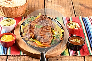 roast beef with seasonings and sliced Ã¢â¬â¹Ã¢â¬â¹barbecue salad served on plate on wooden table